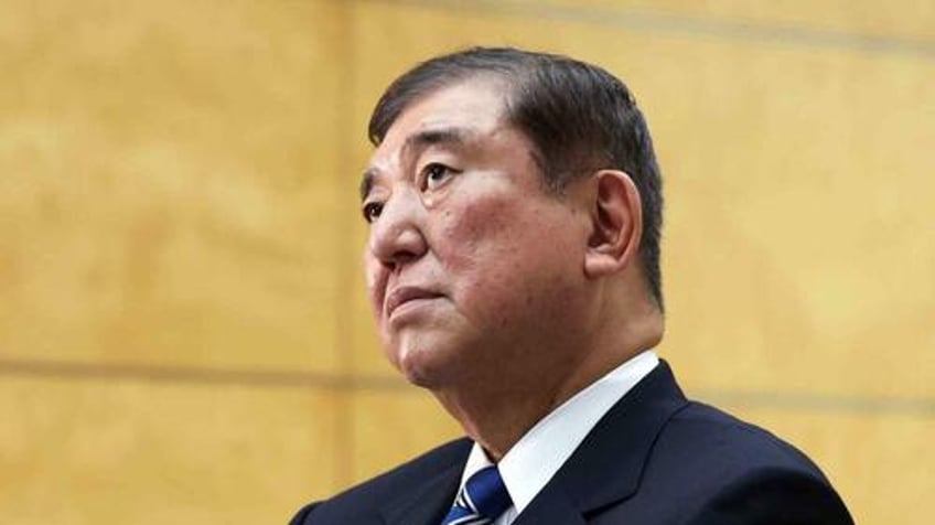 japan pm ishiba vows to stay on despite ruling coalition facing major loss exit polls show