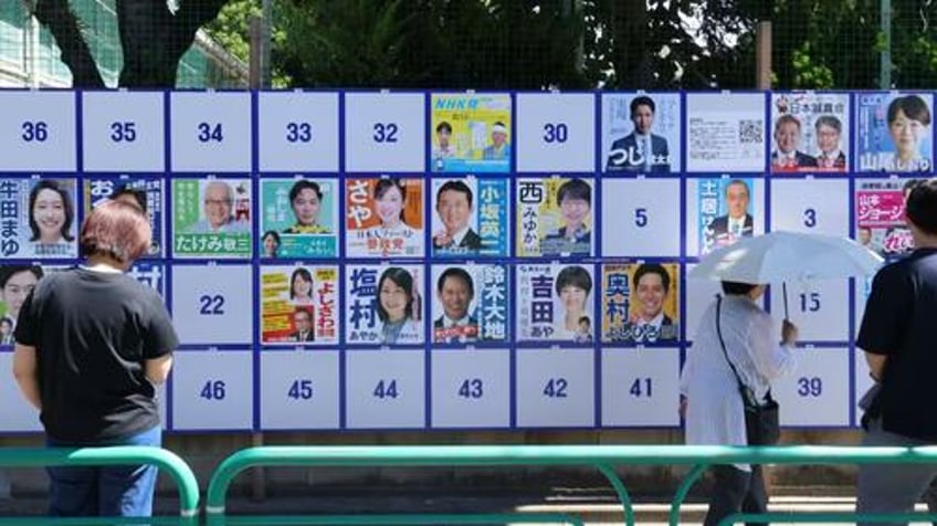 japan pm ishiba vows to stay on despite ruling coalition facing major loss exit polls show