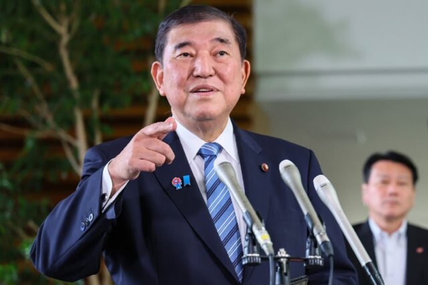 Japan's Prime Minister Shigeru Ishiba responds to questions after a telephone conversation