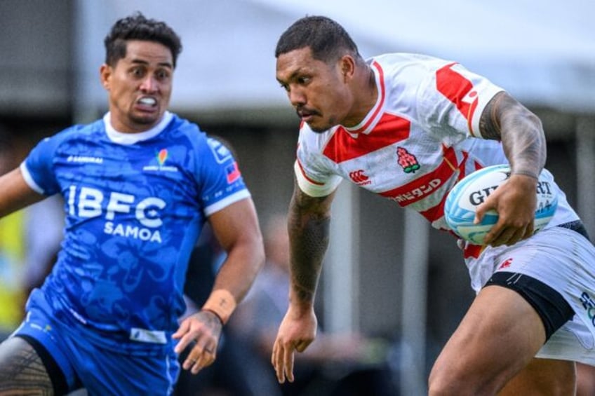 Japan's Malo Tuitama runs at the Samoa defence in Tokyo