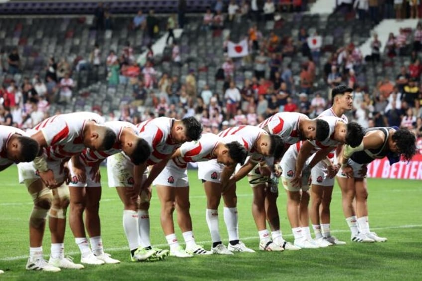 japan win arm wrestle to set up showdown for last eight place