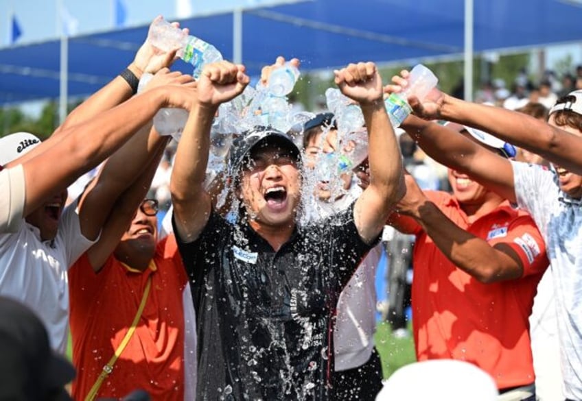 Kensei Hirata (centre) celebrates his victory at the 40th Shinhan Donghae Open