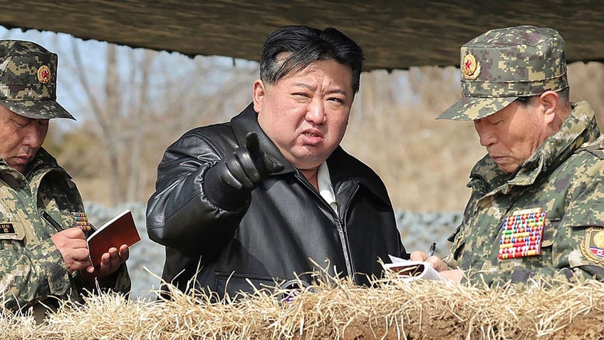 North Korean leader Kim Jong Un, center, supervises artillery firing drills in North Korea