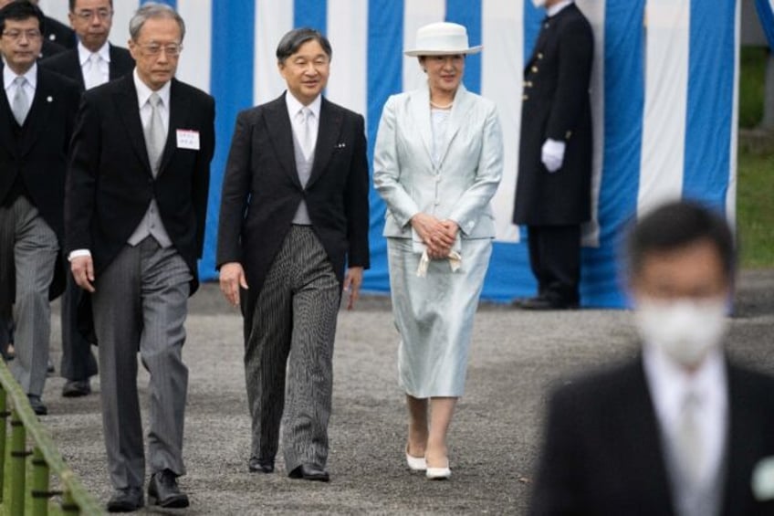 Japan's Emperor Naruhito (2nd R) and Empress Masako (R) walk to greet guests during the sp