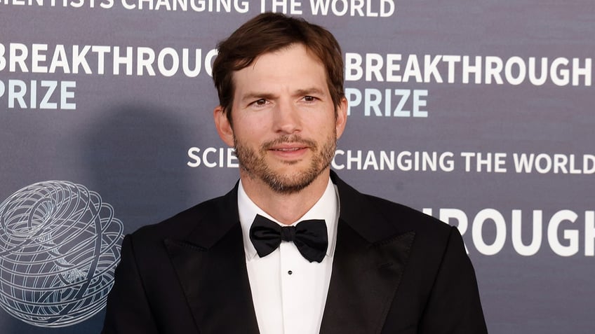 Ashton Kutcher in a tuxedo on the red carpet