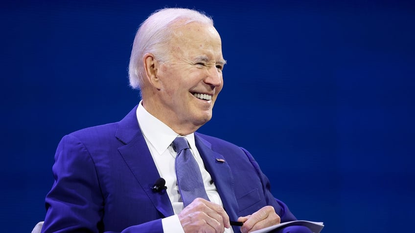 Biden giving a smirk to an unseen crowd