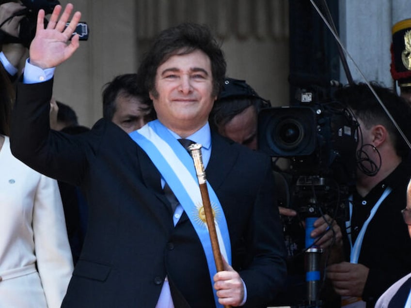 Argentina's new president Javier Milei waves next to his vice president Victoria Villarrue