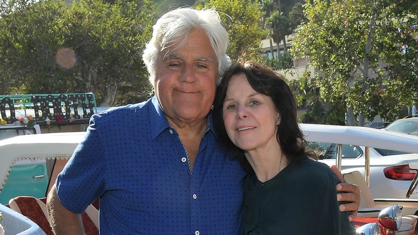Jay Leno and wife Mavis hug at Malibu car show