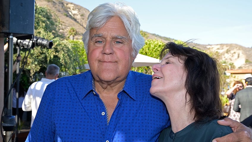 Mavis Leno looks lovingly up at Jay Leno in a bright blue shirt