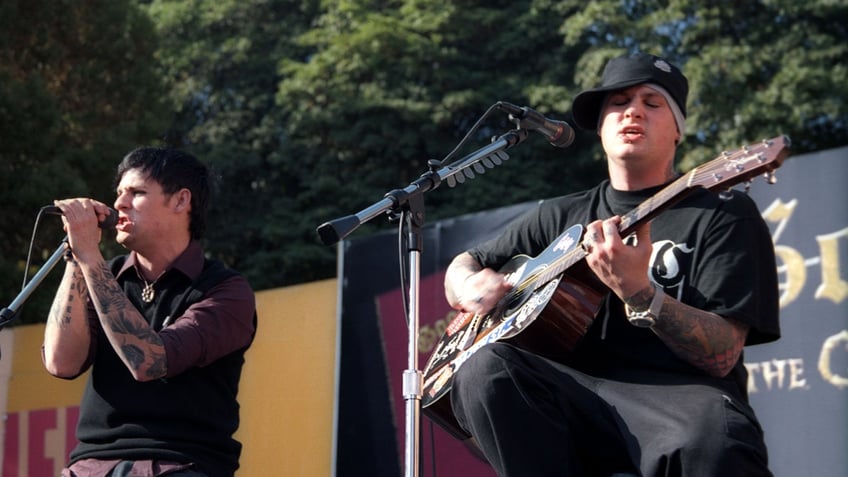 Joel and Benji Madden perform on stage