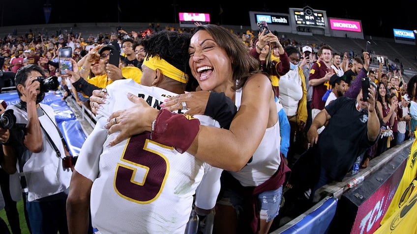 Regina Jackson hugs her son Jayden Daniels