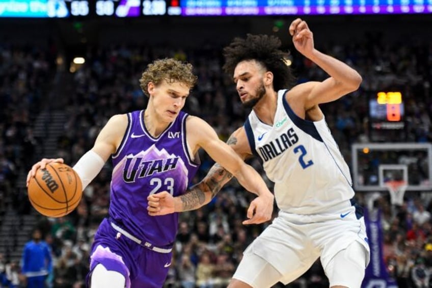 Utah's Lauri Markkanen, at left driving into Dereck Lively of Dallas, has signed an NBA co