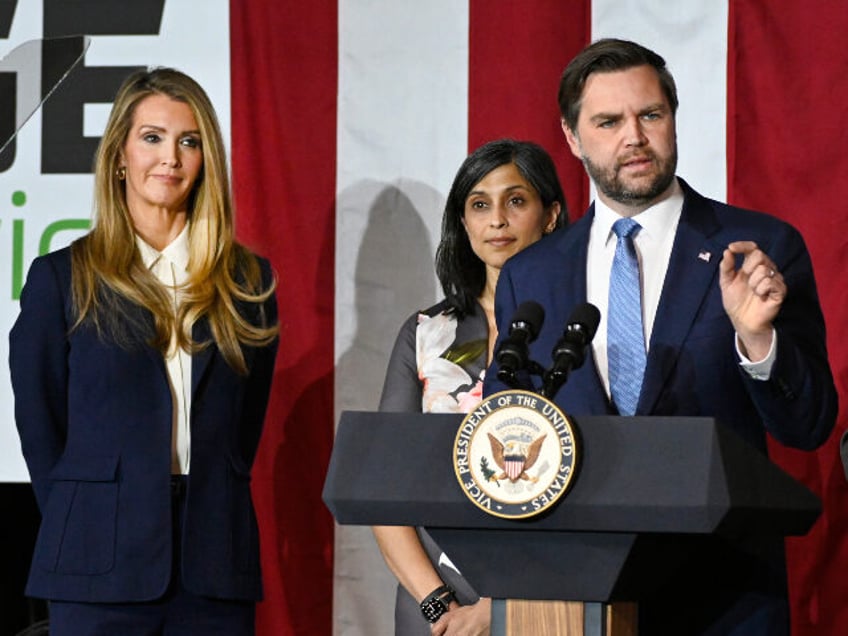 Vice President JD Vance, right, speaks at a rally about "America's industrial re