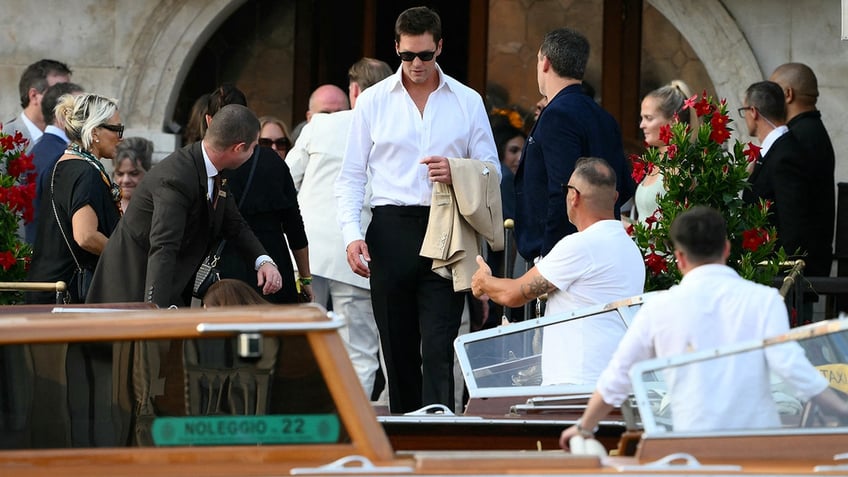 Tom Brady walking to board a taxi boat in Venice