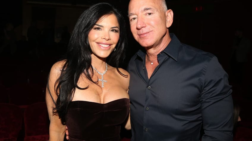 Lauren Sanchez and Jeff Bezos smile while posing for a photo