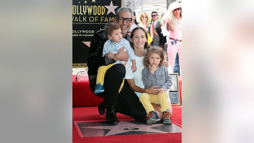 A photo of Jeff Goldblum with his wife and their two sons