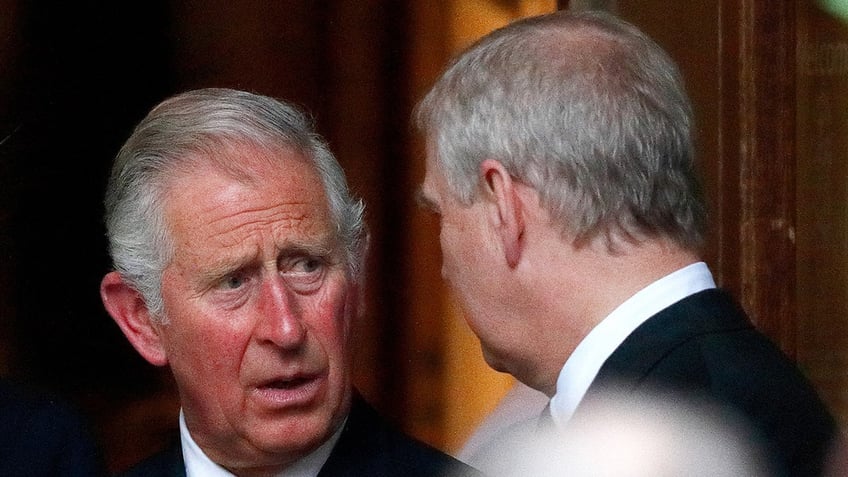 King Charles looking at Prince Andrew and talking sternly