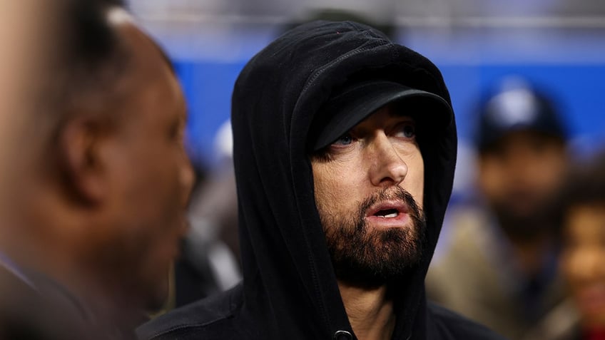 Eminem looks on field