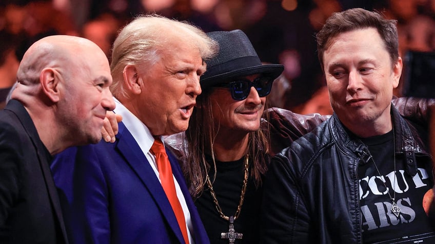 Dana White in black, Donald Trump in a royal blue suit and red tie, Kid Rock wearing a black hat and leather jacket and Elon Musk in a black leather jacket pose for a photo at the UFC 309 event