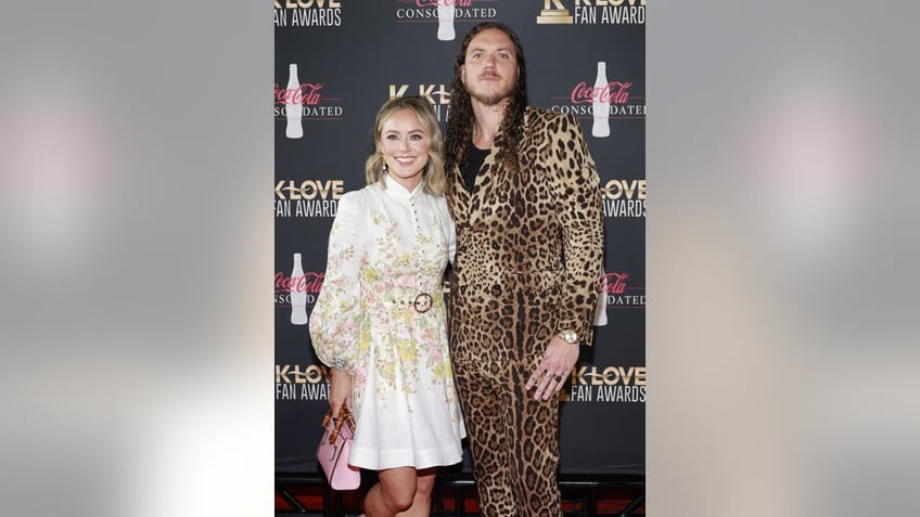 Brandon Lake with his arm around his wife at an event