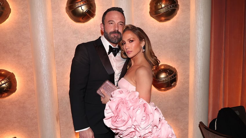 Ben Affleck holding his arm around Jennifer Lopez on the red carpet