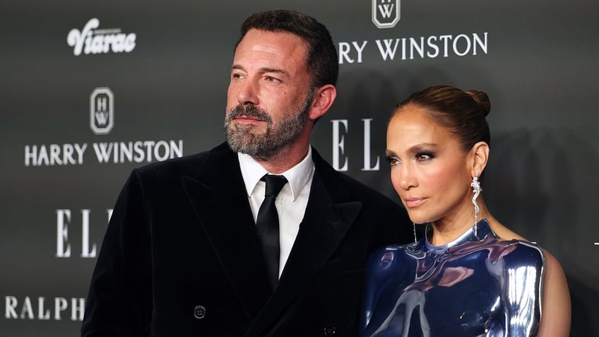 Ben Affleck and Jennifer Lopez posing together on the red carpet