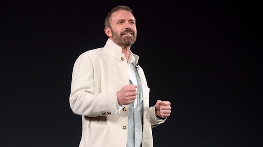 Ben Affleck on stage in a white jacket