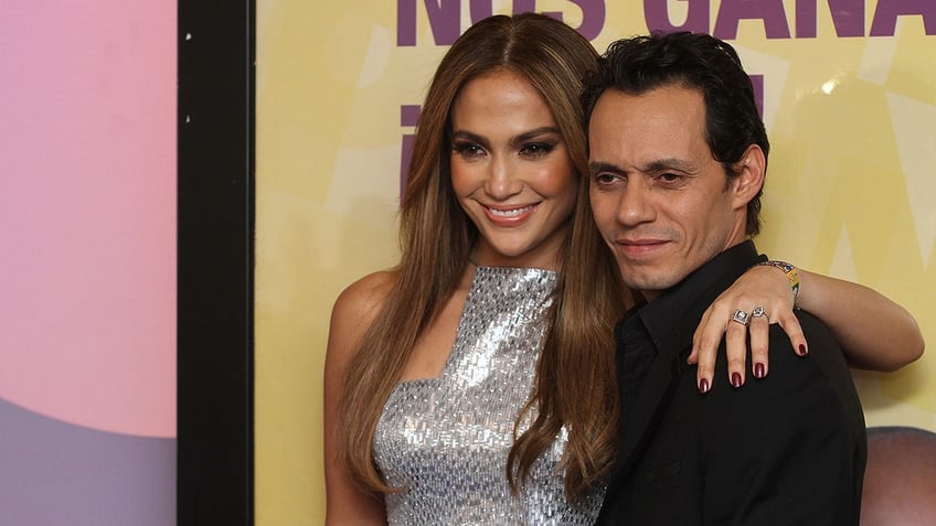 Jennifer Lopez with her arm around Marc Anthony