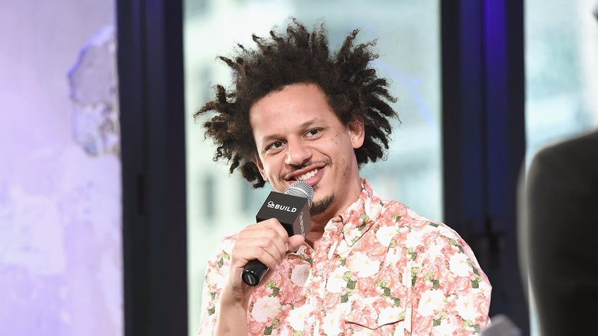 Close up of Eric Andre holding a microphone