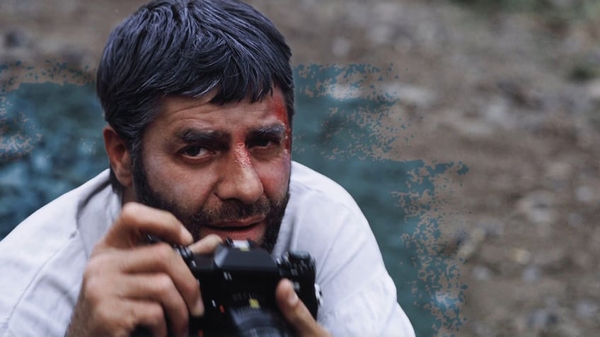 A close-up of Jerry Lewis holding a camera