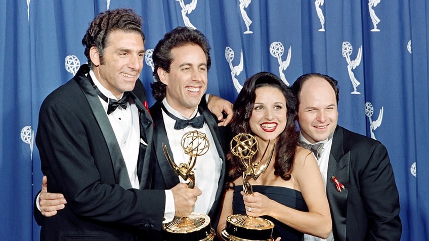 The cast of Seinfeld posing with their Emmys