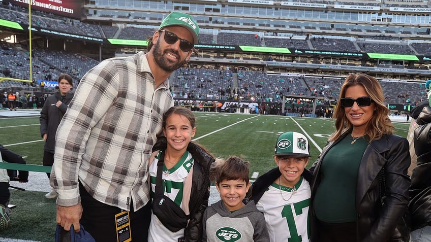 Eric Decker and Jessie James Decker at a Jets game with children Vivianne, Eric Jr, and Forrest