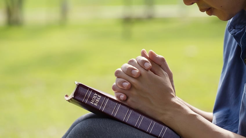 man praying with bible