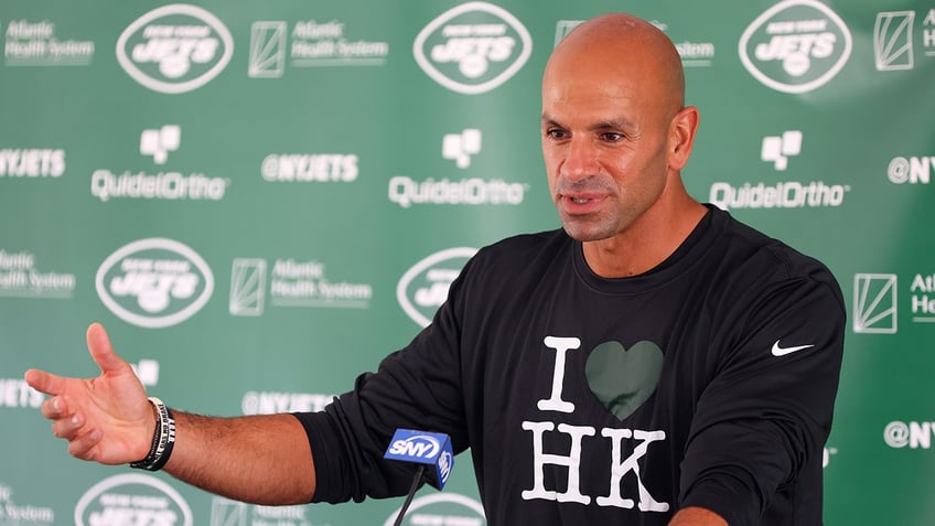 jets head coach reluctantly welcomes hard knocks with sarcastic wardrobe selection