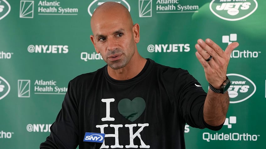 jets head coach reluctantly welcomes hard knocks with sarcastic wardrobe selection