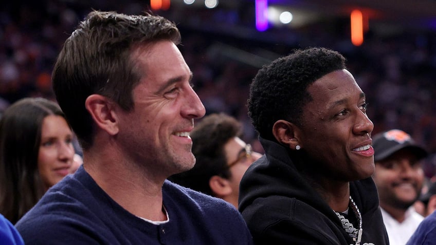 Aaron Rodgers and Sauce Gardner sit courtside at a Knicks game