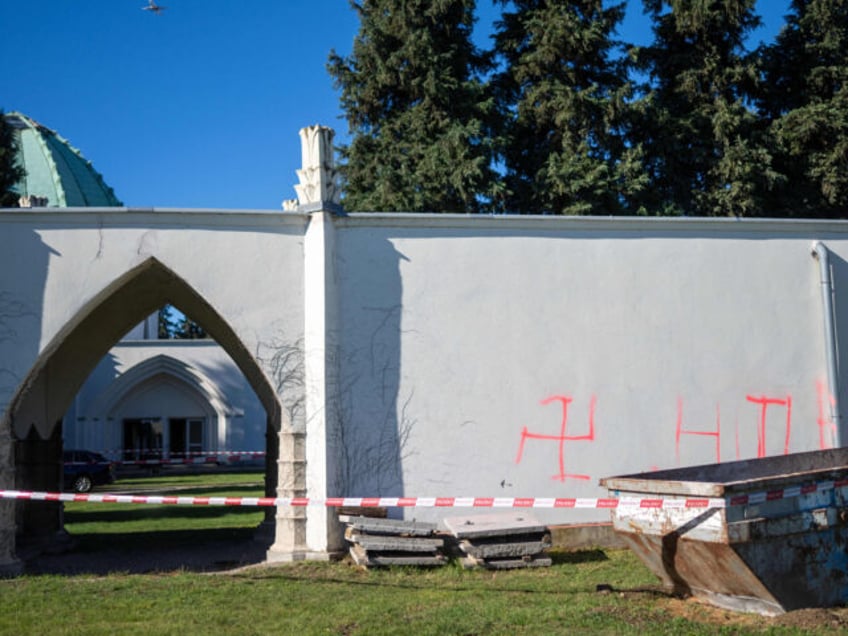 jewish cemetery set on fire and defaced with swastika and hitler graffiti in austria