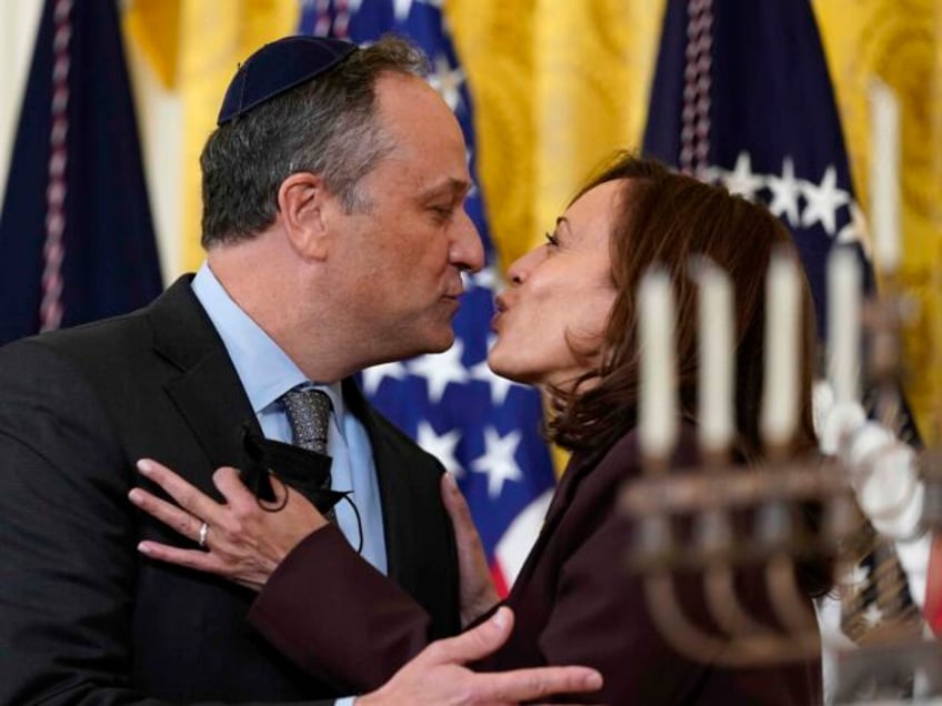 FILE - Vice President Kamala Harris and second gentleman Doug Emhoff kiss during an event