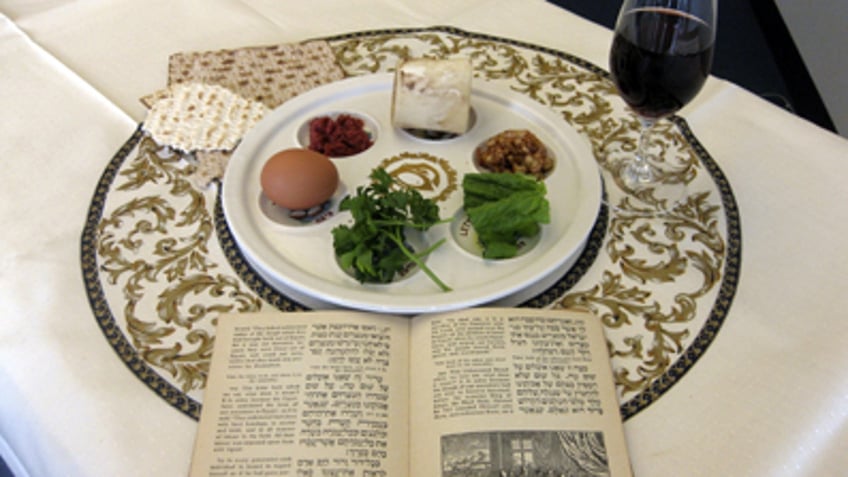 photo shows a 1936 Maxwell House Haggadah alongside a Seder plate in New York. The coffee maker's version of the Seder guide has been offered free at supermarkets with a Maxwell House purchase since the early 1930s. A major overhaul will be out this year in time for the holiday's start April 19. (AP Photo/Stace Maude)