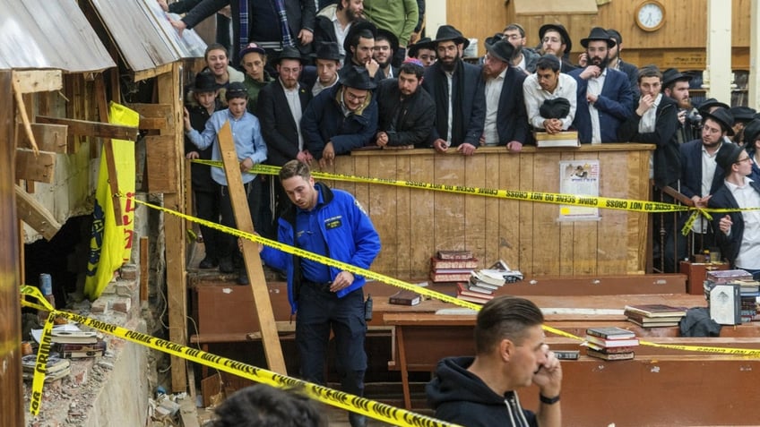 Jewish students watch as police hold perimeter around a Brooklyn synagogue