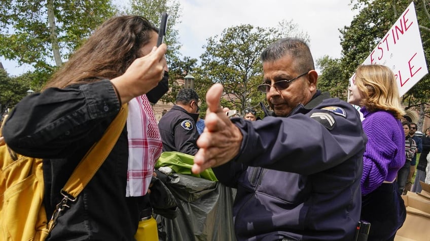 USC protesters interacting with police officer