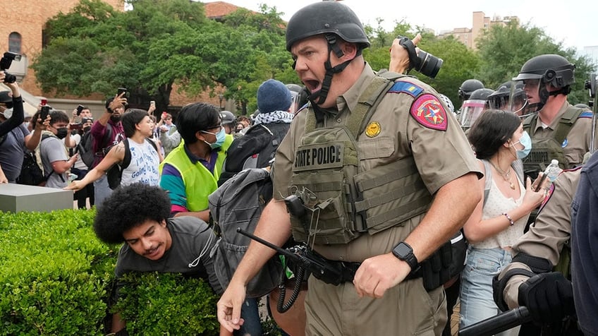 A state trooper knocks down a pro-Palestinian protester