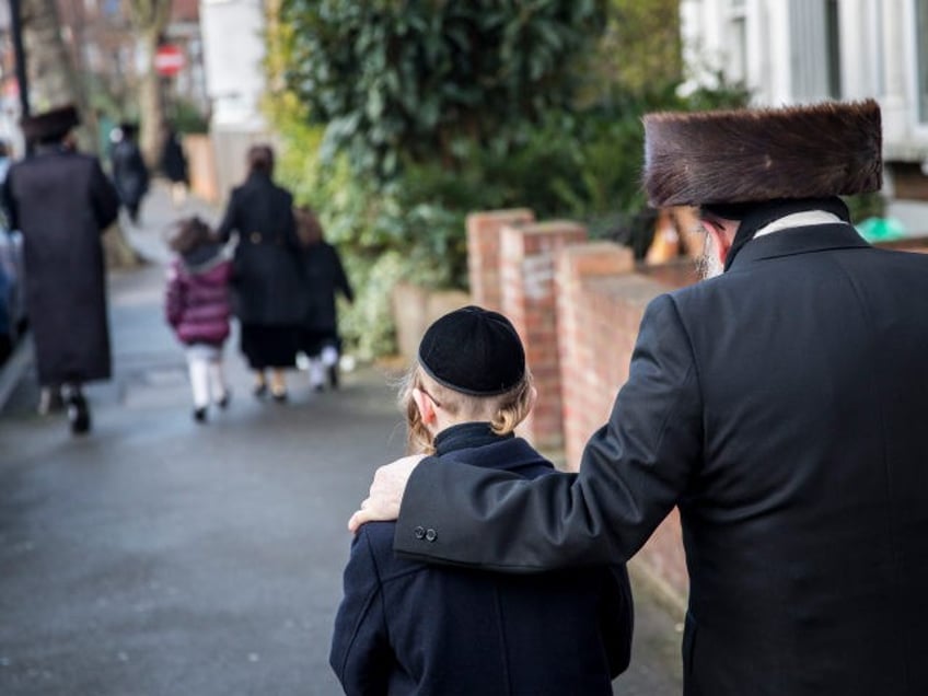 LONDON, ENGLAND - JANUARY 17: Members of the Jewish community walk along the street in the