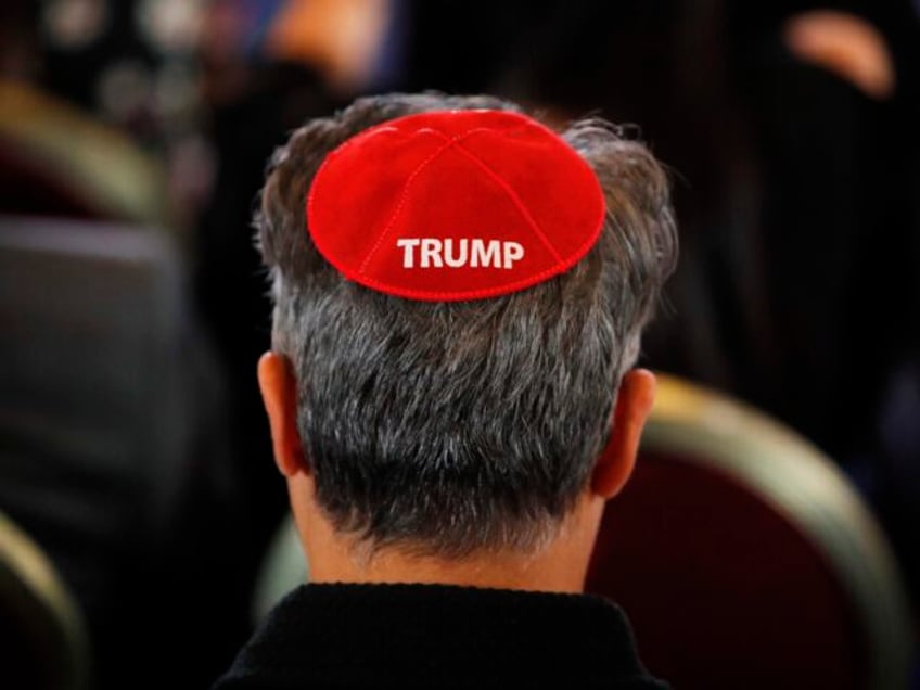 An attendee wears a yarmulke with the word "Trump" before President Donald Trump