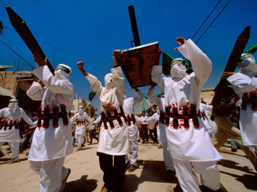 JABALIYA, GAZA STRIP - JANUARY 2001: Hamas militants, carrying replica rockets and wearing