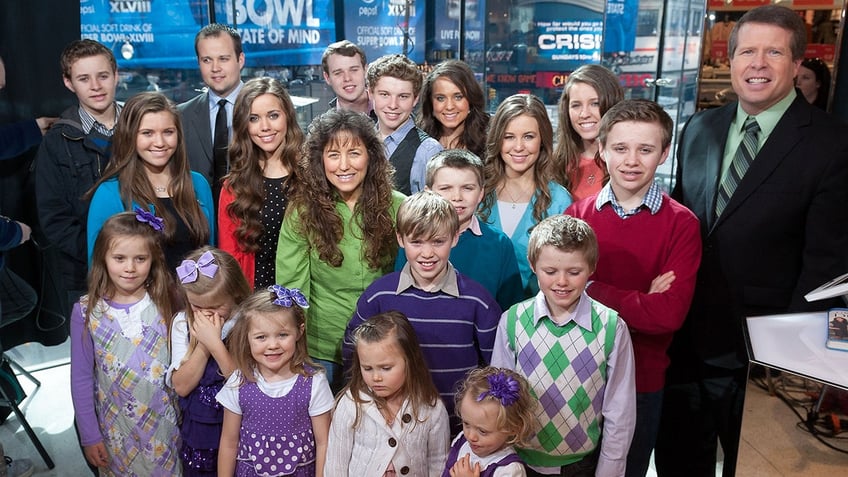 The Duggar family on "Extra" in 2014, one year before their show was cancelled