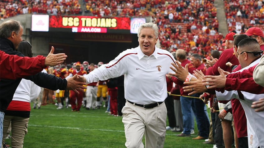 Pete Carroll runs onto the USC field