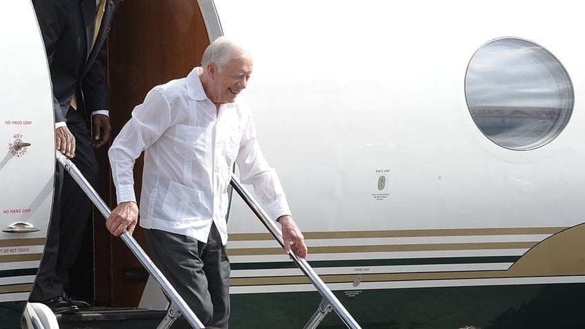 President Jimmy Cater exiting airplane