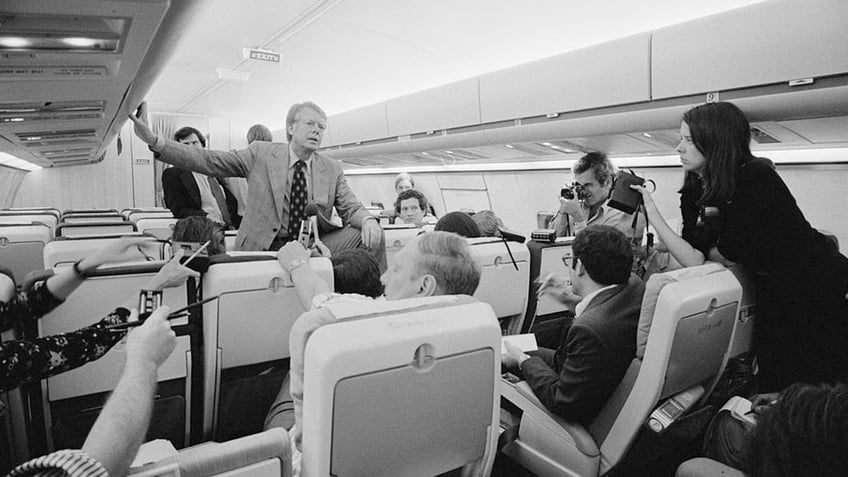 Jimmy Carter holds an informal press conference aboard his plane