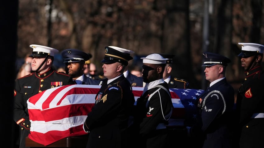 A military body bearer team carries the casket of former President Jimmy Carter into the Jimmy Carter Presidential Library and Museum to lie in repose in Atlanta, Saturday, Jan. 4, 2025. Carter died Dec. 29 at the age of 100. 